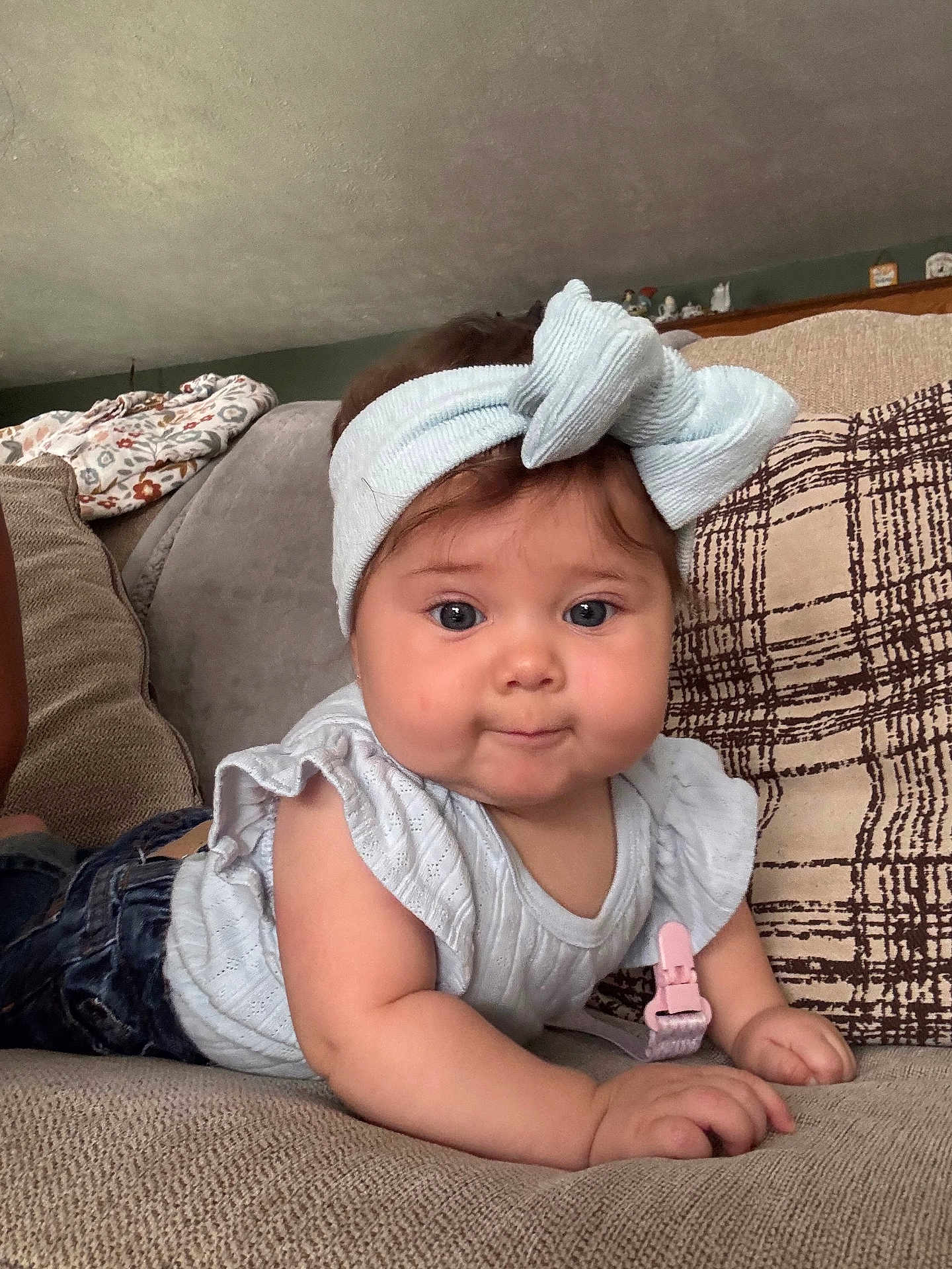 Madison is registered to the contest to win money with this photo: baby, child, headband, blue, couch, pillow, indoor, curious, face, person, clothing, infant, cute, home, soft, smiling, portrait, furniture, hand, sleeveless