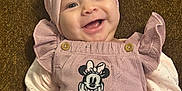 Mia joined the competition — help win amazing prizes! baby, smiling, pink_headband, minnie_mouse, overalls, infant, happy, cute, child, portrait, clothing, baby_girl, hand, background, indoor, headwear, person, closeup, joy, fashion