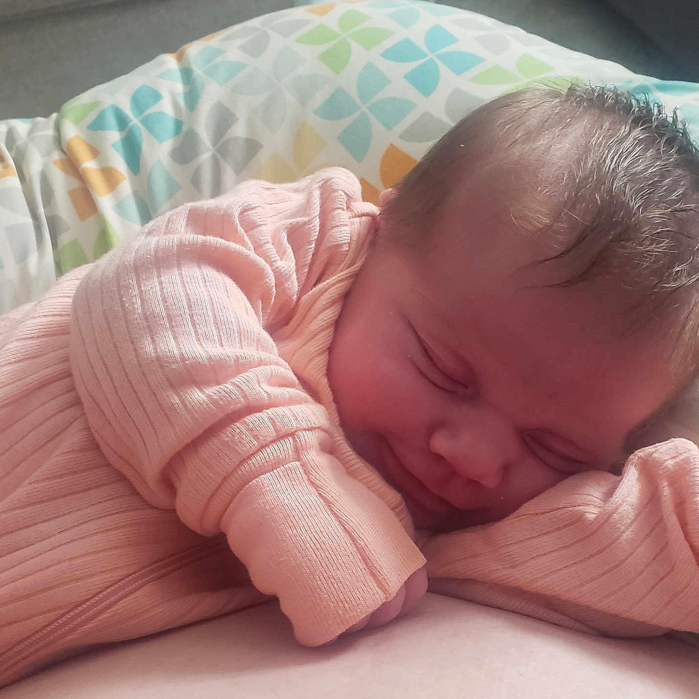 Adelynn is registered to the contest to win money with this photo: baby, bed, blanket, cushion, face, furniture, happy, head, homedecor, newborn, person, photography, portrait, quilt, sleeping, smile