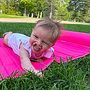 Clark joined the competition — help win amazing prizes! baby, child, grass, pink_mat, tongue_out, outdoor, greenery, playful, cute, smiling, person, nature, summer, infant, happy, toddler, daylight, park, grass_blades, casual_clothing
