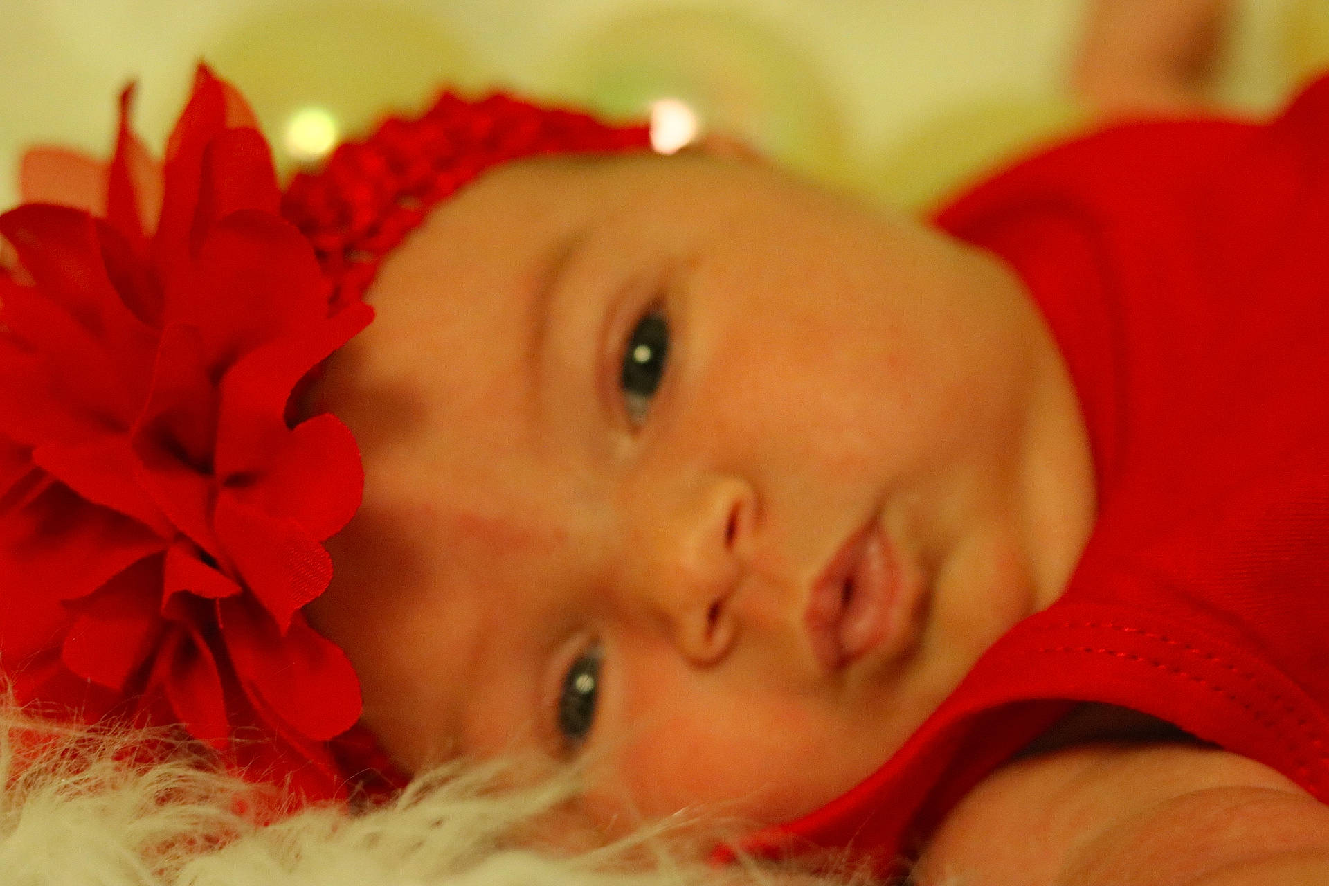 Skylar is registered to the contest to win money with this photo: baby, cheek, child, close_up, ear, eye, face, hair_accessory, head, iris, lip, mouth, nose, person, photography, portrait_photography, red, skin, smile, toddler