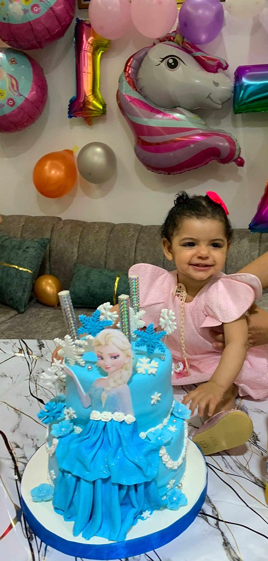 Woujoud a rejoint le concours — aidez-le/la à gagner de superbes lots ! child, toddler, birthday_cake, frozen_theme, blue_cake, balloons, pink_dress, smiling, party, celebration, sofa, cushions, table, decorations, snowflakes, happy, indoors, cake_decoration, person, festive