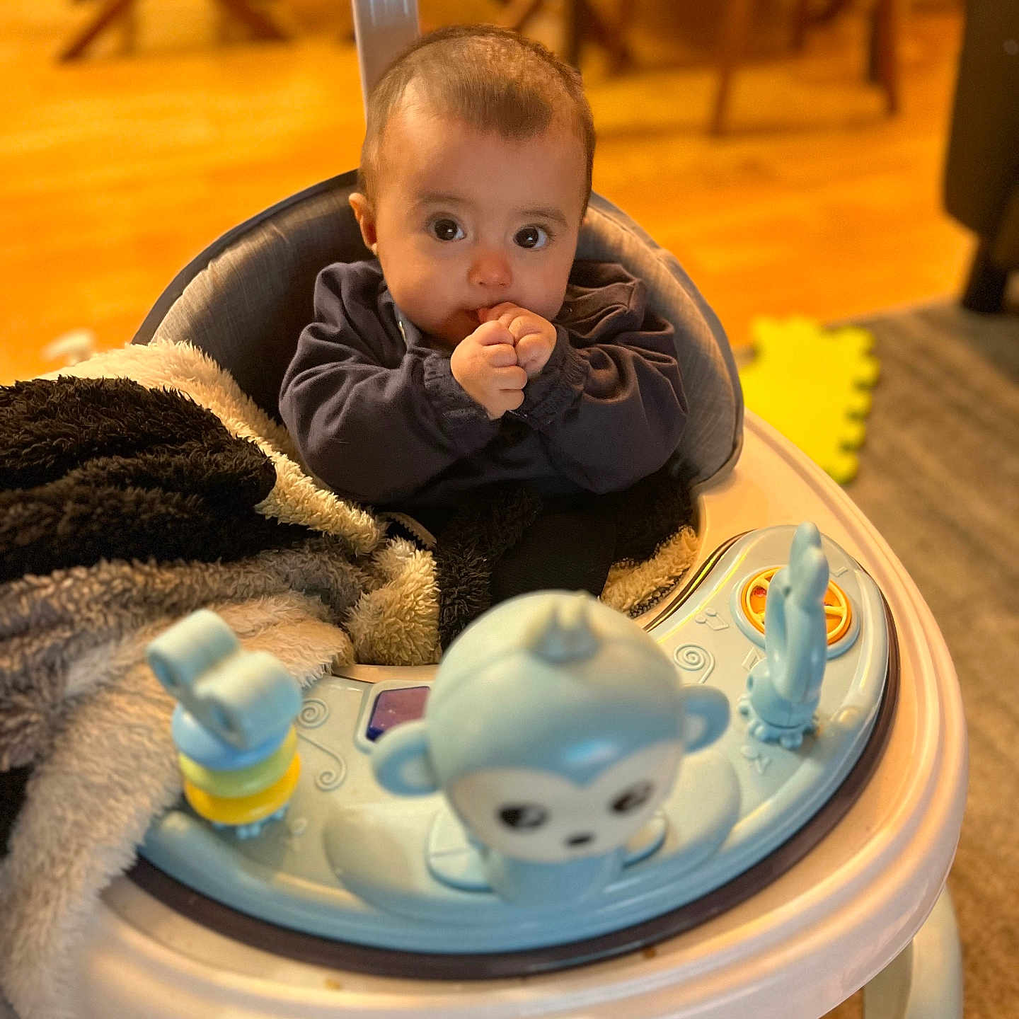 Milagros Sofia participe au concours pour gagner de l'argent avec cette photo : baby, blanket, child, childcare, cozy, curious, cute, face, floor, furniture, hands, home, indoor, infant, monkey_toy, play, toy, walker, wood, young