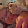 bedroom, black_heart_stickers, casual_clothing, cat, close_up, cozy, cute, feline, glasses, hand, indoors, kitten, orange_cat, person, portrait, selfie, smile, wall_art, warm_lighting, white_cat