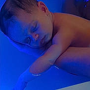 Leona participe au concours pour gagner de l'argent avec cette photo : baby, newborn, sleeping, bathtub, water, blue_light, infant, parent_hand, arm, skin, closeup, portrait, peaceful, cradled, soothing, resting, indoor, neonatal, soft_lighting, portraiture