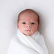 Louie is registered to the contest to win money with this photo: newborn, baby, infant, wrapped, blanket, white, knitted, portrait, face, head, closeup, skin, eyes, cute, child, soft, texture, calm, innocence, young