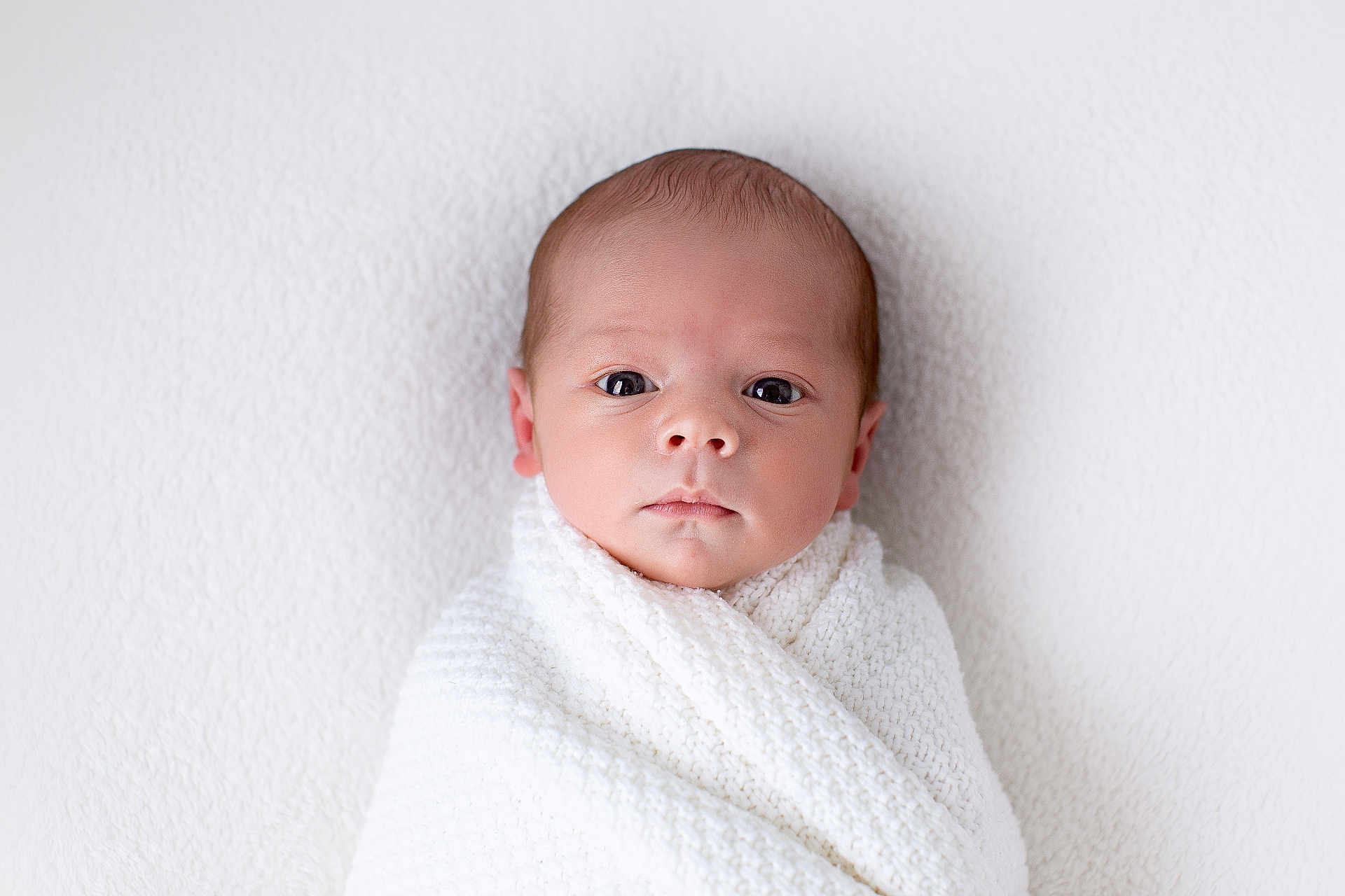 Louie is registered to the contest to win money with this photo: newborn, baby, infant, wrapped, blanket, white, knitted, portrait, face, head, closeup, skin, eyes, cute, child, soft, texture, calm, innocence, young