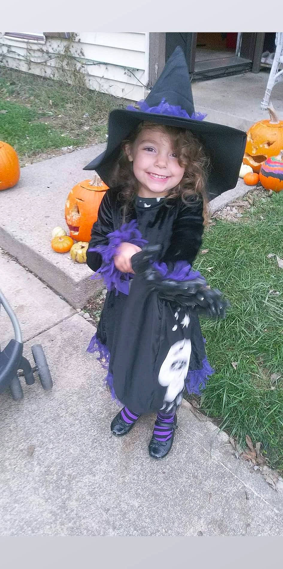 Alina is registered to the contest to win money with this photo: calabaza, child, clothing, community, costume_hat, fun, hat, headgear, joy, leisure, person, plant, pumpkin, purple, recreation, shoe, smile, sun_hat, tire, toddler