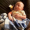 baby, sleeping, blanket, pacifier, couch, infant, hand, clothing, face, rest, comfort, indoors, peaceful, nap, soft, plush, child, warm, relaxation, portrait