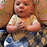 Dylan joined the competition — help win amazing prizes! baby, blanket, clothing, colorful, cozy, cushion, cute, expression, face, hands, ice_cream, indoor, infant, pattern, portrait, rainbow, resting, soft_texture, wrapped, young_child
