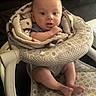 baby, blanket, baby_seat, infant, cute, child, indoors, pattern, fabric, person, legs, feet, skin, head, face, expression, comfort, soft, warm, sitting