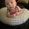 Dylan joined the competition — help win amazing prizes! baby, infant, cushion, pattern, face, hands, eyes, expression, indoors, person, clothing, red_trim, curious, looking, toddler, soft_light, background, pillow, skin, closeup