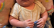 Dylan is registered to the contest to win money with this photo: baby, blanket, child, closeup, clothing, cozy, curious, cute, expression, face, hands, head, indoor, infant, newborn, pillow, portrait, rainbow, skin, soft