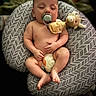 baby, sleeping, pacifier, plush_toy, cushion, patterned, diaper, infant, relaxation, child, cute, skin, hand, foot, indoors, comfort, rest, peaceful, newborn, portrait