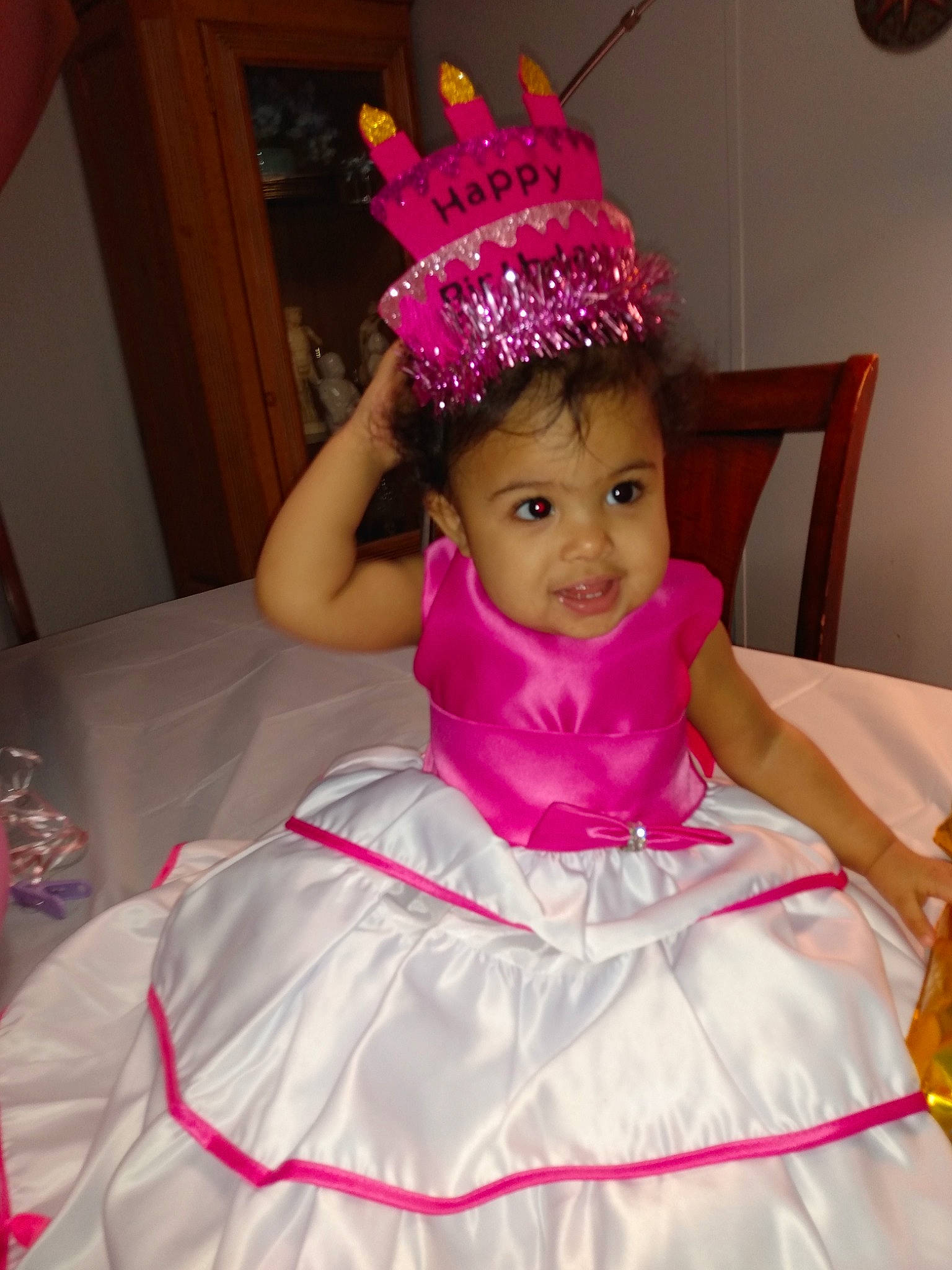 Reign'Amor is registered to the contest to win money with this photo: baby_toddler_clothing, ballet_tutu, bridal_accessory, child, costume_hat, dress, event, facial_expression, fashion_design, hair_accessory, happy, head, headgear, headpiece, magenta, person, pink, purple, tiara, tradition