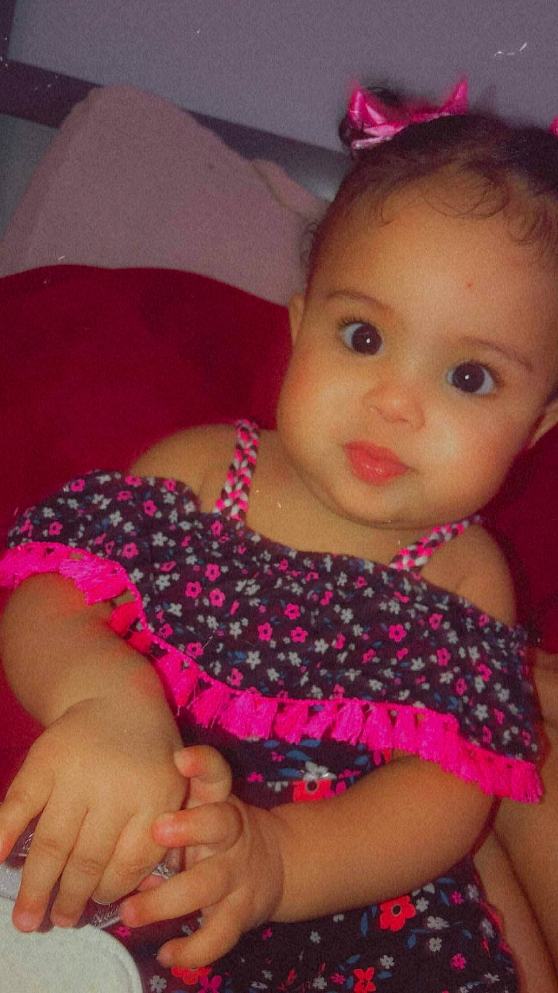 Reign'Amor is registered to the contest to win money with this photo: baby_toddler_clothing, cheek, chin, eye, eyelash, finger, happy, head, iris, lip, magenta, mouth, nail, nose, organ, person, pink, purple, red, skin