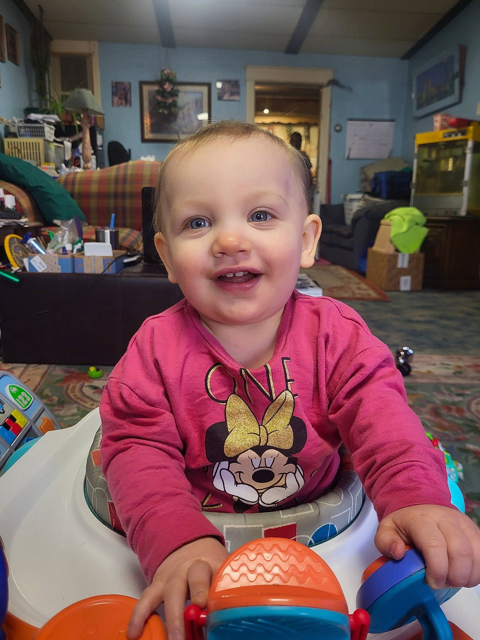 Izzabella is registered to the contest to win money with this photo: baby, baby_toddler_clothing, chair, cheek, child, event, flooring, fun, hairstyle, happy, joy, leisure, person, picture_frame, recreation, riding_toy, room, sitting, smile, t_shirt