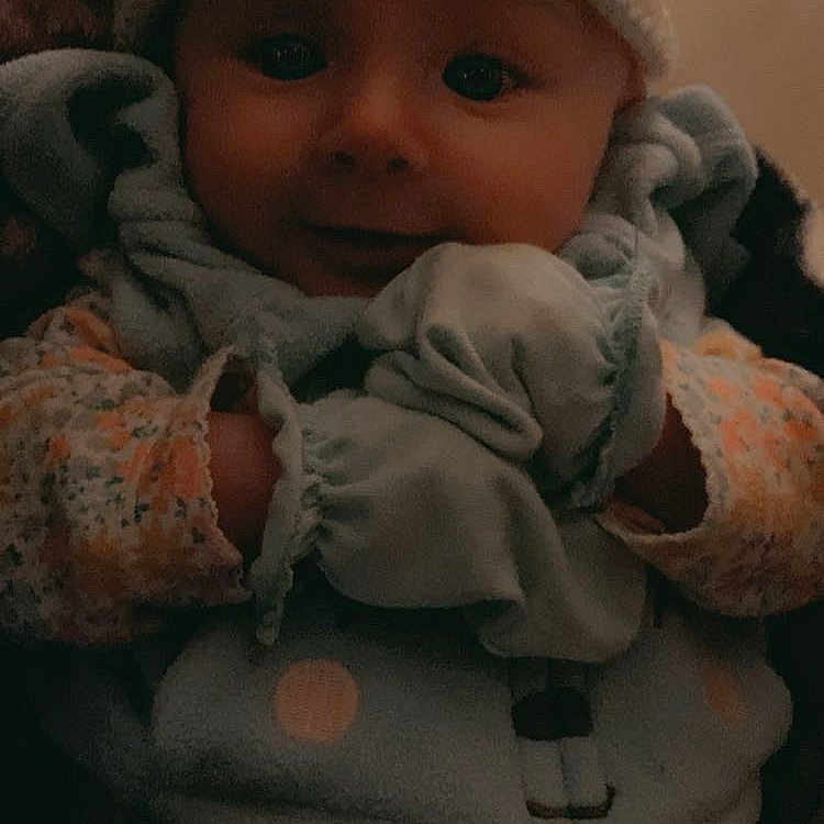 Willow is registered to the contest to win money with this photo: baby, beanie, bonnet, cap, clothing, coat, face, glove, hat, head, hood, hoodie, jacket, knitwear, newborn, person, photography, portrait, sweater, sweatshirt