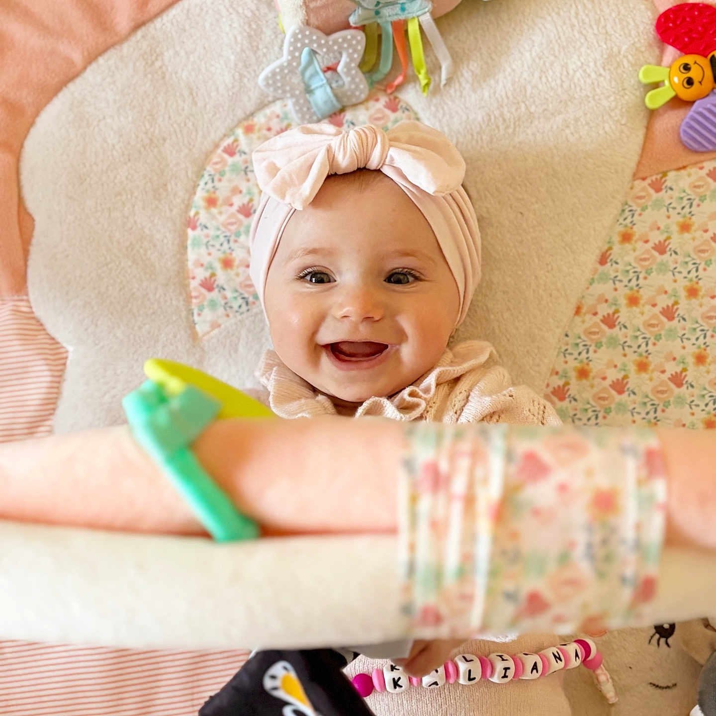 Kaliana Levignat participe au concours pour gagner de l'argent avec cette photo : accessories, baby, bed, bonnet, bracelet, cap, clothing, couch, crib, face, furniture, happy, hat, head, infantbed, jewelry, person, photography, portrait, smile