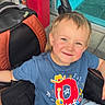 Tatum joined the competition — help win amazing prizes! child, smiling, stroller, blue_tshirt, jeans, urban, outdoor, happy, boy, casual_clothing, colorful, red_pillar, turquoise_wall, daylight, portrait, seatbelt, short_hair, playful, young, expression