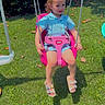 Tatum joined the competition — help win amazing prizes! child, toddler, swing, playground, grass, outdoor, summer, sunlight, blue_clothing, pink_swing, sandals, greenery, park, daytime, happy, smiling, person, ropes, leaves, nature