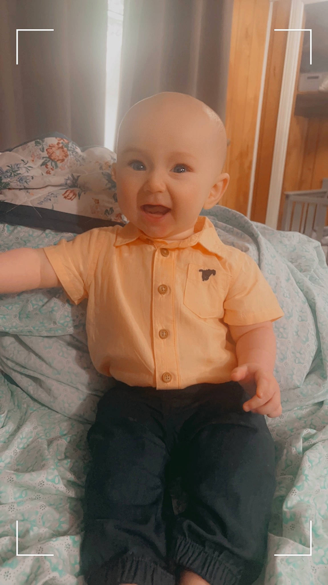 Tatum is registered to the contest to win money with this photo: baby, chair, cheek, child, comfort, dress_shirt, eye, facial_expression, happy, head, nose, person, product, skin, sleeve, smile, standing, textile, toddler, trunk