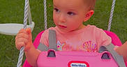 Everleigh is registered to the contest to win money with this photo: toddler, child, swing, pink, playground, outdoor, grass, greenery, pigtails, jeans, shirt, rope, seat, toy, little_tikes, daylight, young_child, park, cute, playing