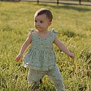 Everleigh joined the competition — help win amazing prizes! toddler, child, outdoor, grass, greenery, sunlight, field, dress, floral_pattern, pants, nature, young_child, portrait, curious, standing, summer, daylight, baby, cute, person