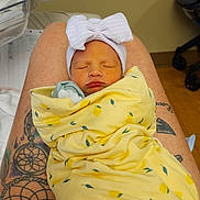 Wrenleigh is registered to the contest to win money with this photo: architecture, baby, bed, blanket, building, childbirth, couch, face, furniture, head, hospital, newborn, person, photography, portrait, skin, sleeping, tattoo, towel, wood
