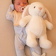 Nova is registered to the contest to win money with this photo: newborn, baby, sleeping, pacifier, stuffed_animal, bunny, plush_toy, pajamas, footwear, indoor, soft_texture, cute, child, infant, peaceful, toddler, sleep, comfort, rest, toy