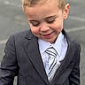 child, boy, suit, tie, smile, portrait, outdoor, cute, fashion, formal, young, person, short_hair, happy, face, clothing, standing, background_blur, dimple, casual