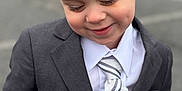 Lorenzo is registered to the contest to win money with this photo: accessories, blazer, boy, child, clothing, coat, face, formalwear, happy, head, jacket, male, necktie, person, photography, portrait, shirt, suit, tie, tuxedo