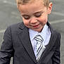Lorenzo is registered to the contest to win money with this photo: accessories, blazer, boy, child, clothing, coat, face, formalwear, happy, head, jacket, male, necktie, person, photography, portrait, shirt, suit, tie, tuxedo