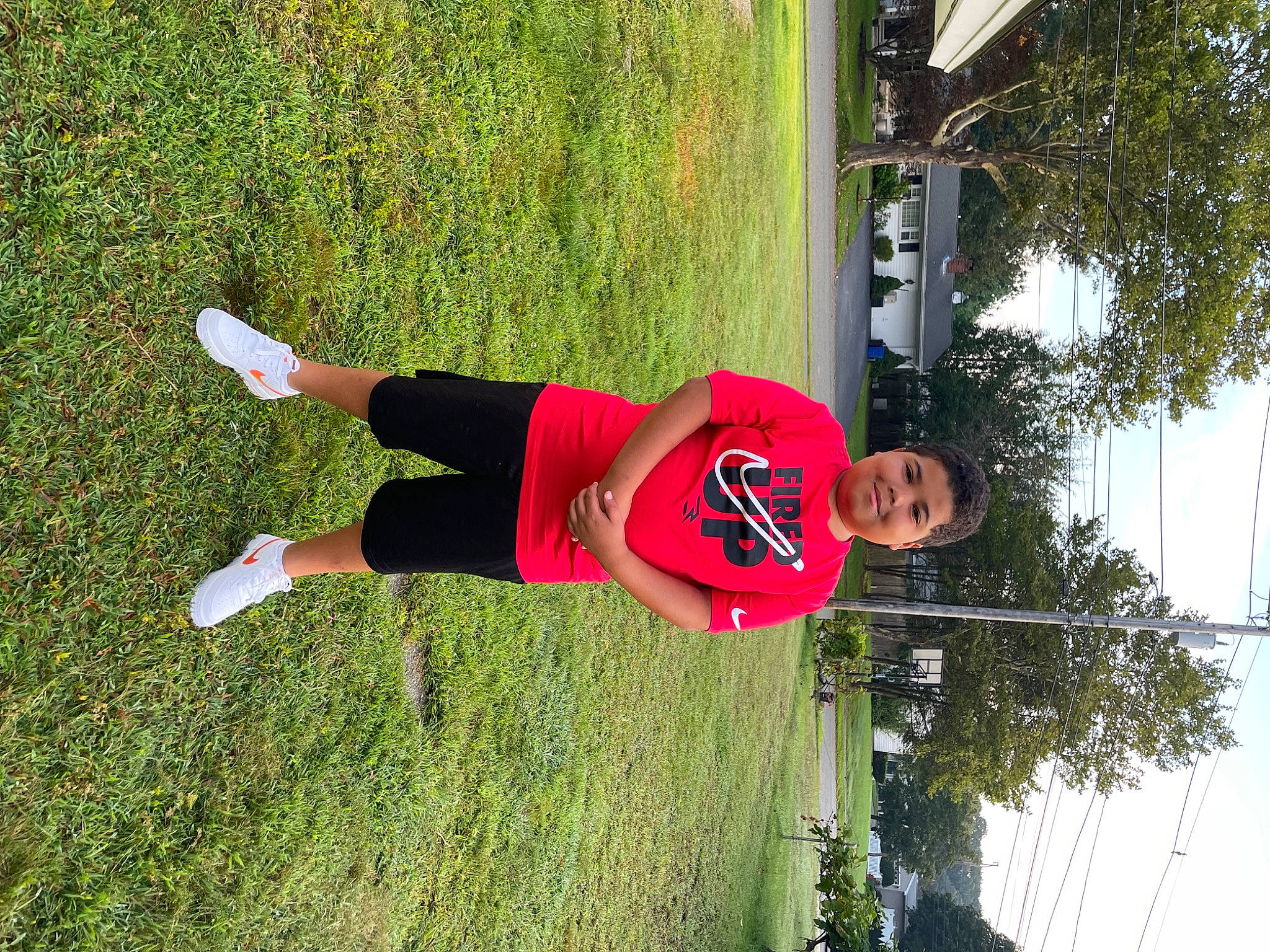 Amari is registered to the contest to win money with this photo: balance, elbow, fun, grass, human_leg, joy, knee, leisure, people_in_nature, person, physical_fitness, plant, pole, recreation, shorts, sky, sports_uniform, sportswear, t_shirt, thigh