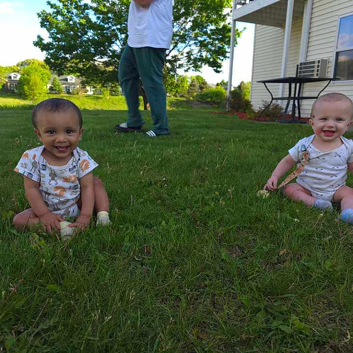 Junior And Jaxton is registered to the contest to win money with this photo: air_conditioner, baby, child, clothing, daytime, footwear, grass, greenery, happy, house, nature, outdoor, person, playful, sitting, smiling, sunny_day, table, window, yard