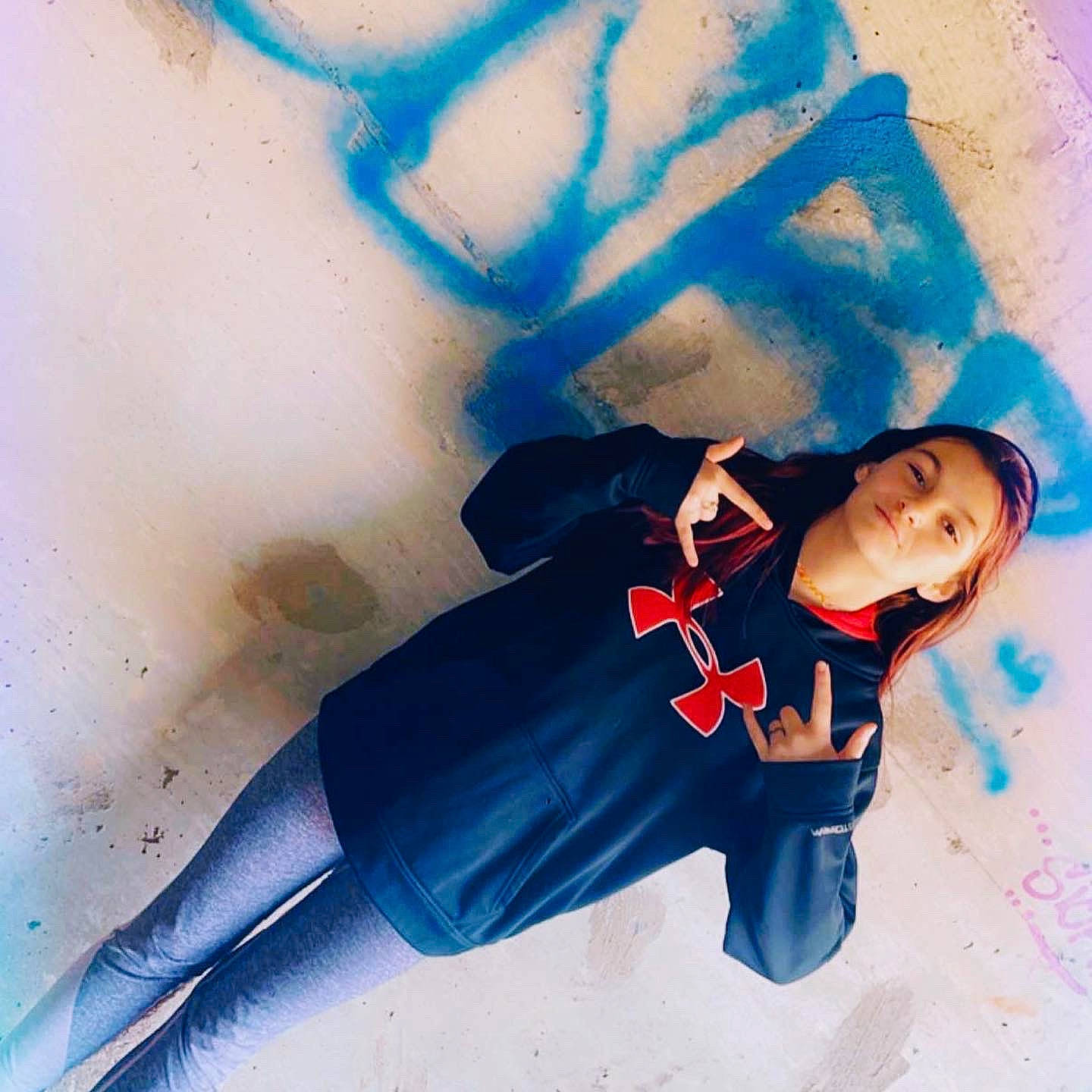 Kaitlynn is registered to the contest to win money with this photo: art, artist, black_hair, cool, denim, electric_blue, eyewear, fictional_character, flash_photography, font, gesture, happy, headgear, human_leg, knee, person, sleeve, sportswear, t_shirt, thigh