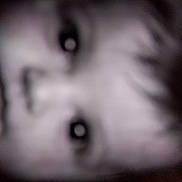 Amra participe au concours pour gagner de l'argent avec cette photo : child, face, closeup, blurry, eyes, portrait, candid, monochrome, grayscale, eye_reflection, nose, mouth, cheek, soft_focus, low_light, out_of_focus, head, expression, mystery, indoor