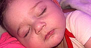 Jeremiah is registered to the contest to win money with this photo: baby, sleeping, child, closeup, face, hand, pink, blanket, soft, cute, infant, cozy, rest, peaceful, skin, eyelashes, clothing, portrait, indoors, head