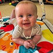 Freddie joined the competition — help win amazing prizes! baby, smiling, play_mat, indoor, child, happy, infant, face, toy, colorful, pattern, clothing, hands, head, floor, couch, home, cute, portrait, baby_girl