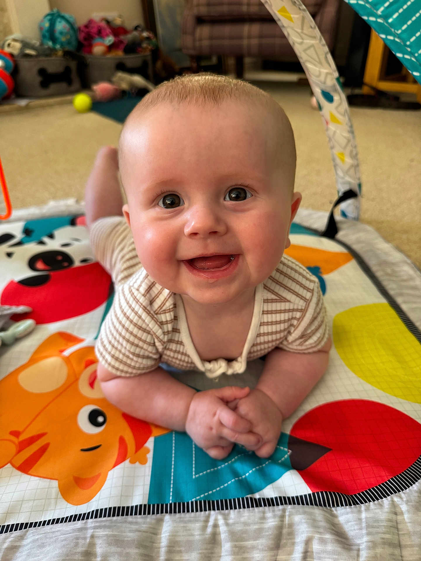 Freddie joined the competition — help win amazing prizes! baby, smiling, play_mat, indoor, child, happy, infant, face, toy, colorful, pattern, clothing, hands, head, floor, couch, home, cute, portrait, baby_girl