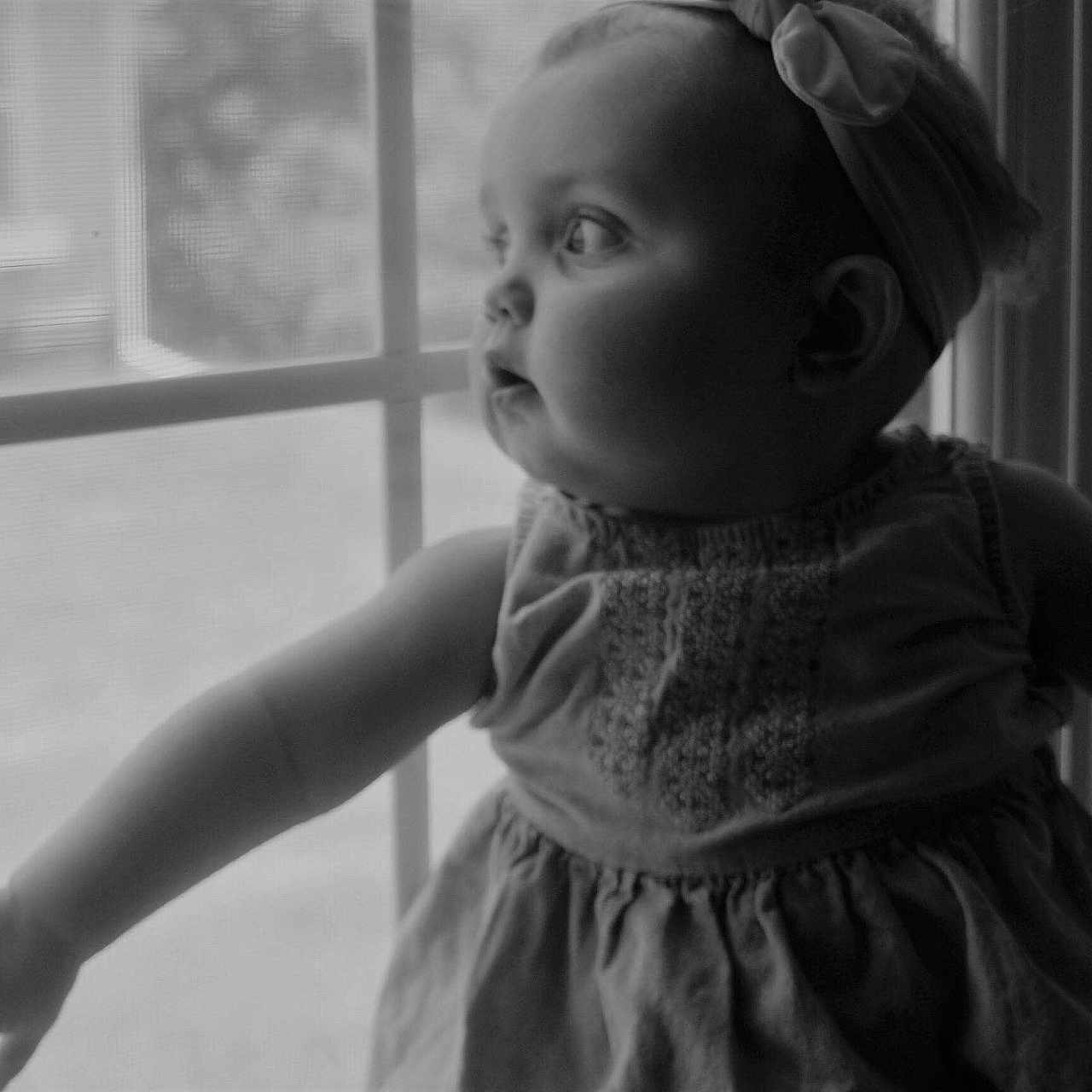 Noel is registered to the contest to win money with this photo: black, black_and_white, child, eye, girl, happiness, human, monochrome, monochrome_photography, person, photograph, photography, portrait_photography, smile, snapshot, standing, toddler, white