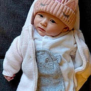 Lynna participe au concours pour gagner de l'argent avec cette photo : baby, infant, hat, knit_hat, unicorn, clothing, cute, face, person, child, pink, white, gray, soft, warm, lying_down, indoor, portrait, cozy, apparel