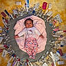 Tayloure is registered to the contest to win money with this photo: baby, infant, child, lying_down, pink_blanket, pink_clothing, hello_kitty, nursery, medical_supplies, syringes, medicine, packaging, yellow_rug, overhead_view, portrait, indoor, toy, crib, smiling, colorful