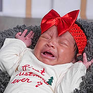 Tayloure joined the competition — help win amazing prizes! newborn, baby, infant, crying, red_bow, headband, portrait, close_up, lying_down, blanket, gray_blanket, white_clothing, green_pants, indoors, face, hands, closed_eyes, open_mouth, textile, holiday_outfit