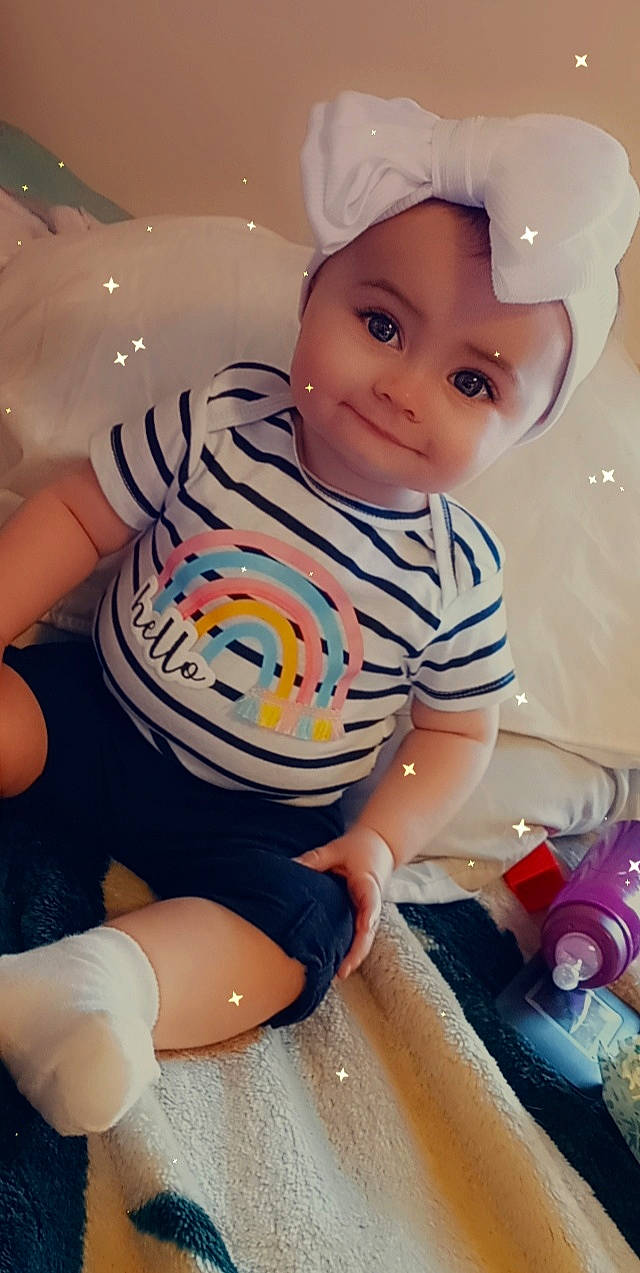 Chevelle is registered to the contest to win money with this photo: arm, baby, baby_toddler_clothing, blue, cheek, child, facial_expression, fun, happy, mouth, organ, person, pink, product, skin, sleeve, smile, thigh, toddler, water