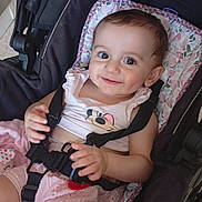 Gabie participe au concours pour gagner de l'argent avec cette photo : baby, child, smiling, stroller, seatbelt, cute, indoors, infant, clothing, dimple, face, person, happy, pink, pattern, sitting, young_child, cute_outfit, comfort, baby_girl