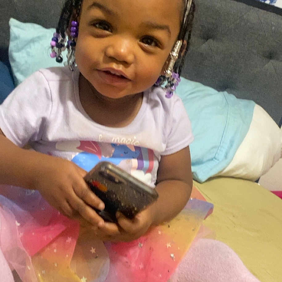 Anayah is registered to the contest to win money with this photo: accessories, bed, bedroom, child, couch, cushion, earring, electronics, face, female, furniture, girl, head, homedecor, indoors, jewelry, person, photography, portrait, room