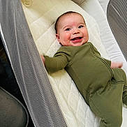 James joined the competition — help win amazing prizes! baby, infant, crib, onesie, smile, happy, mesh, fabric, child, sleeping_area, cute, person, lying_down, soft, comfort, indoors, young, cheerful, playful, baby_accessory
