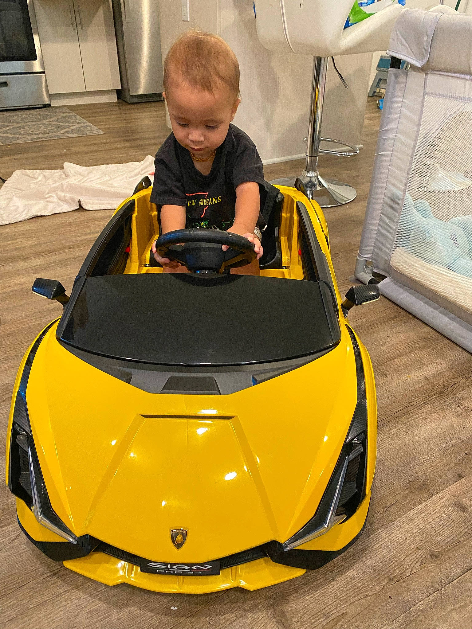 Cassius is registered to the contest to win money with this photo: automotive_design, automotive_exterior, automotive_lighting, automotive_wheel_system, bumper, car, headlamp, hood, jacket, motor_vehicle, orange, person, personal_luxury_car, photograph, tints_and_shades, toddler, vehicle, vehicle_door, white, windshield
