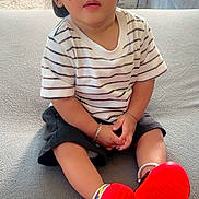 Rayshan joined the competition — help win amazing prizes! toddler, child, baby, cap, striped_shirt, shorts, red_shoes, bracelet, earrings, couch, indoor, carpet, curious, sitting, portrait, person, home, furniture, cute, fashion